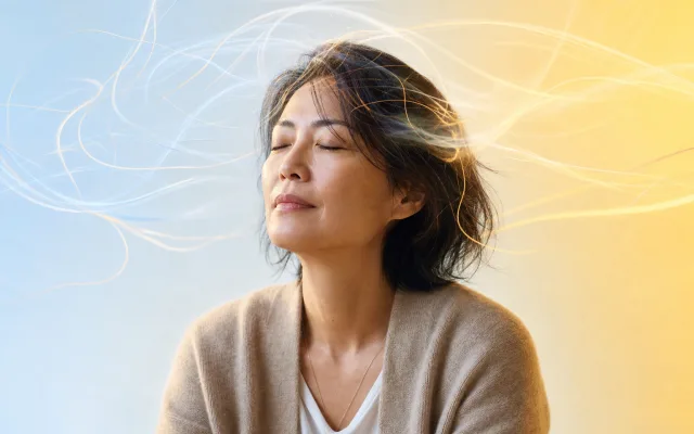 Person sitting quietly in soft blue light with translucent thought threads unraveling gently around them