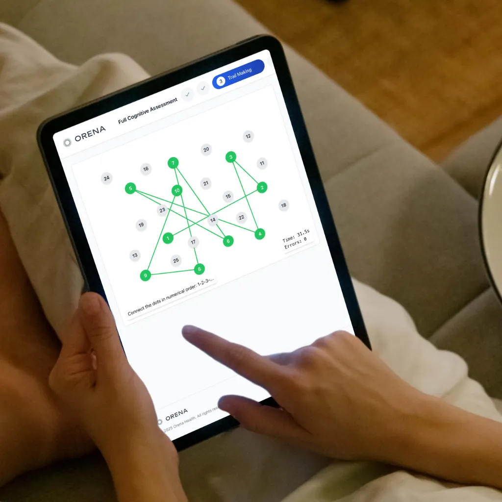 Hands using an iPad to complete the Orena cognitive assessment at home